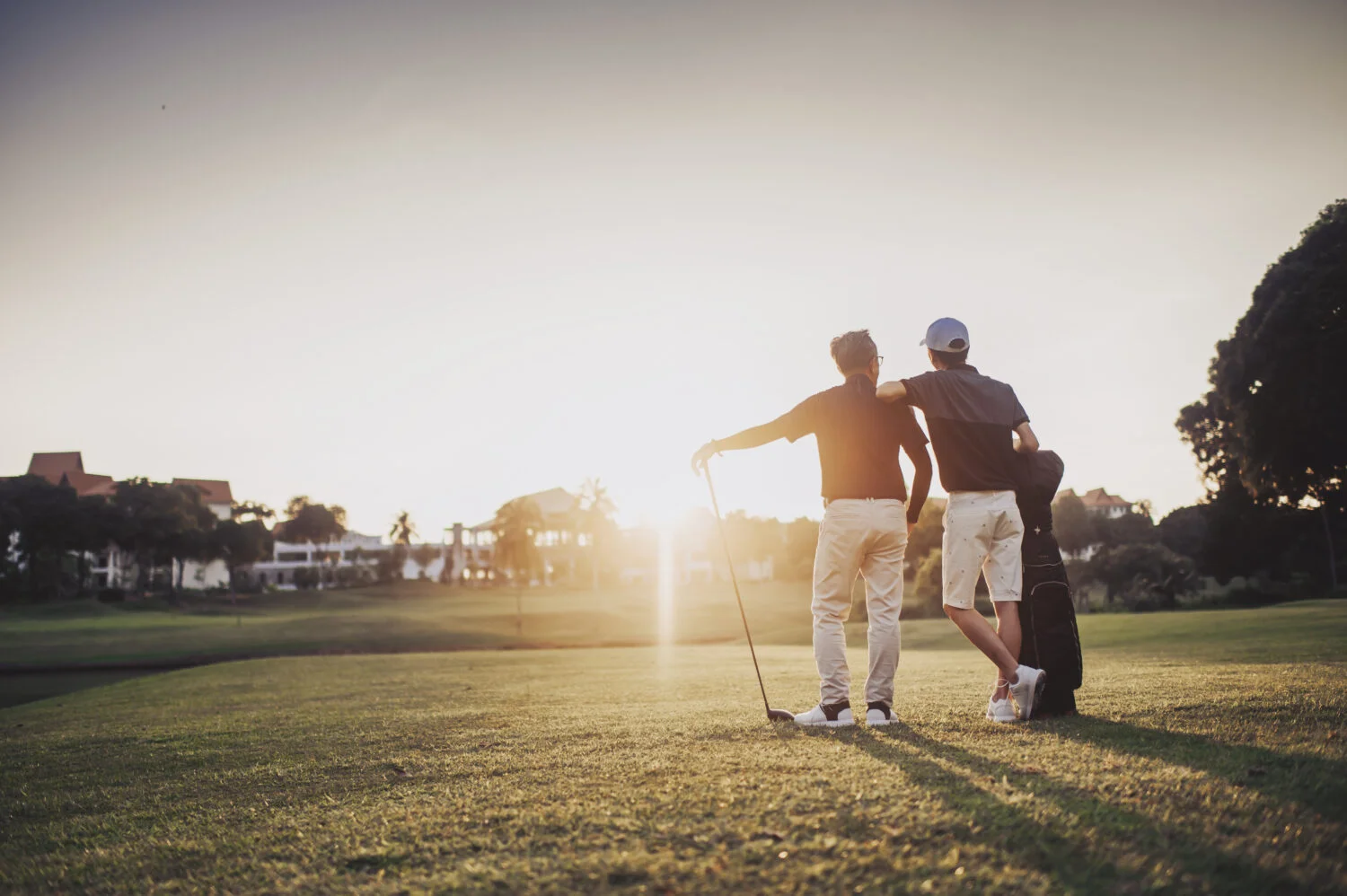 an asian chinese senior man golfer carrying his golf club on his shoulder and looking at the view in golf course