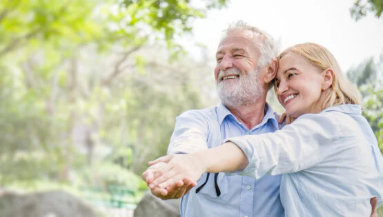 Retirement Community in Boca Raton, FL | Sunscape Boca Raton Happy old couple smiling dancing in a park on a sunny day, hoot senior couple relax in the forest spring summer time. Healthcare lifestyle retirement concept banner