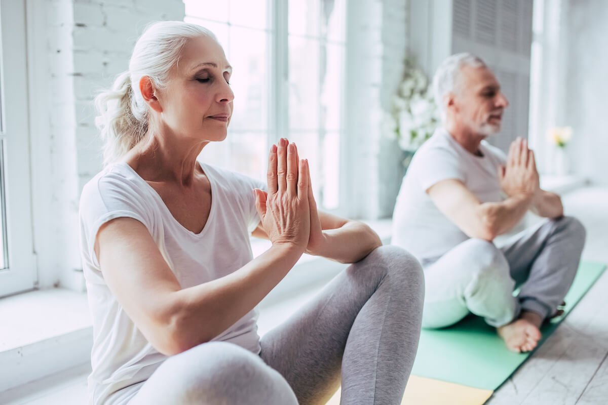 What Are the 8 Dimensions of Wellness? | Sunscape Boca Raton Senior couple is doing fitness training at home Doing yoga together Healthy lifestyle concept