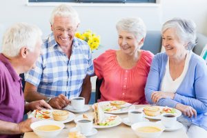 Group of Happy Seniors Eating Lunch_Sunscape™ Boca Raton