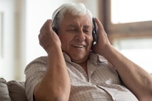 Senior Man Listening to Music with Headphones_Memory Care in Boca Raton