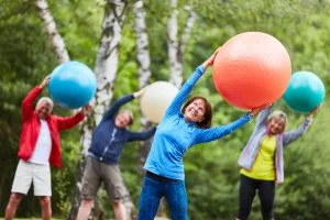 Group of Seniors Exercising Outdoors_Myths About Assisted Living