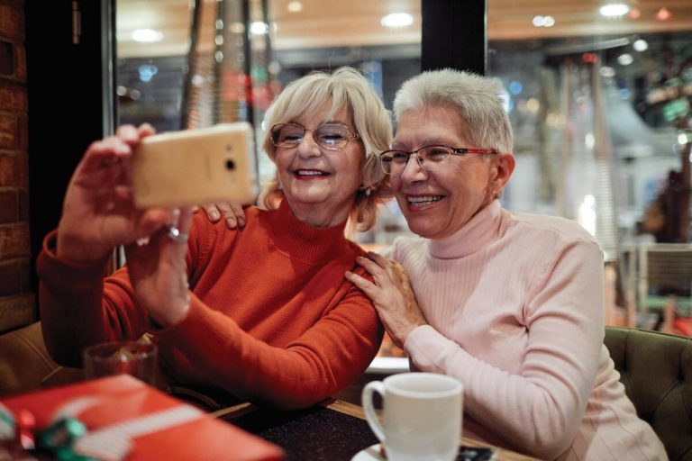 Luxury Senior Living Community | Sunscape Boca Raton™ Senior taking selfie at Holiday Open House Sunscape Boca Raton