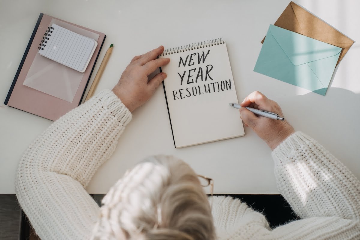 Enhance Life with New Year's Resolutions for Healthy Aging Senior Woman Writing New Year's Resolutions_Sunscape™ Boca Raton
