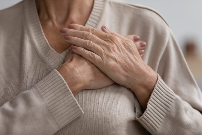 Promote Heart Health This February (And All Year!) Senior Woman Holding Hands Over Heart_Sunscape™ Boca Raton