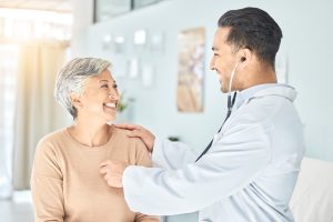 Promote Heart Health This February (And All Year!) Male Doctor Listening to Senior Woman's Heart_Heart Health