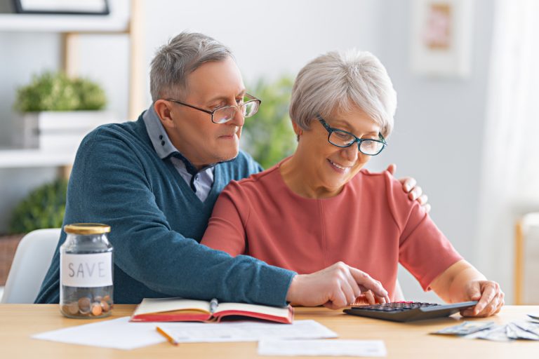 Boca Raton Senior Living Costs vs. Remaining at Home Senior Couple Looking Over Finances_Sunscape Boca Raton Senior Living