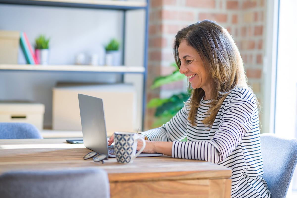 Smiling Mature Woman Looking at Laptop_Boca Raton Senior Living