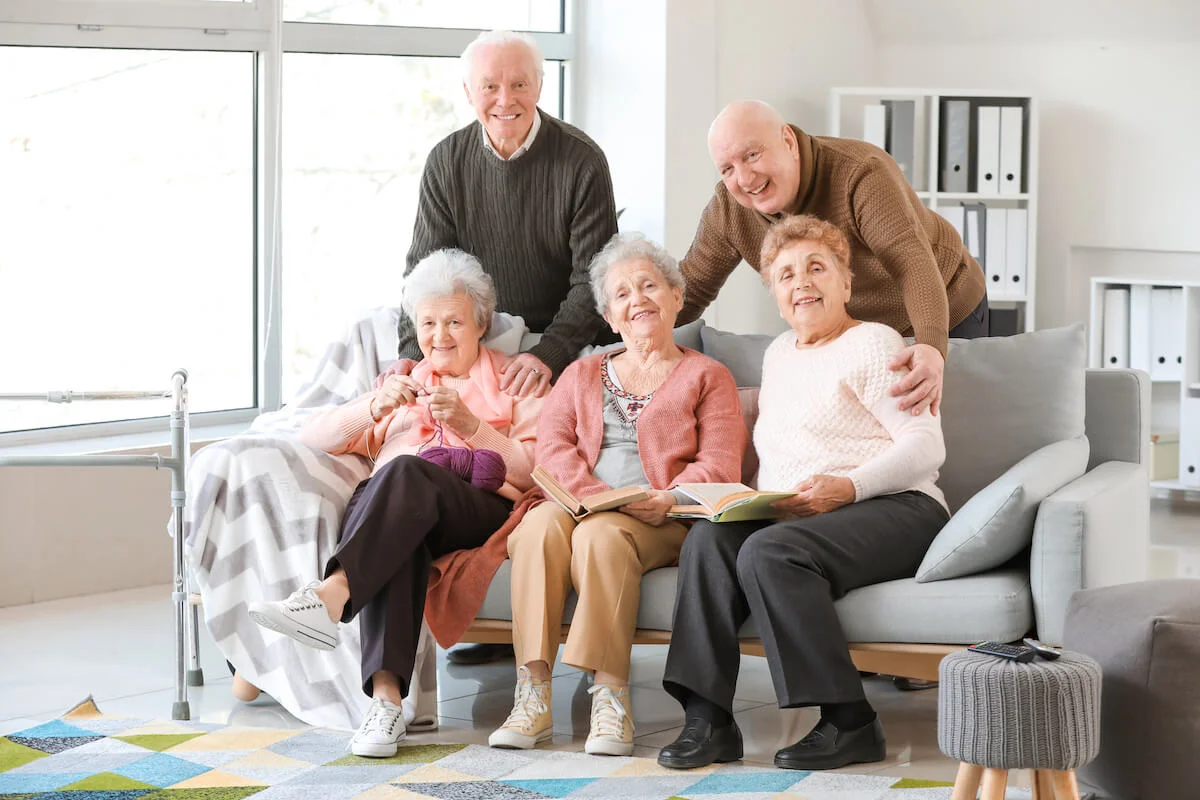 Picture of five seniors at an assisted living community posing together.