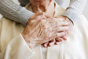 3 Ways to Pay for Boca Raton Assisted Living Caregiver taking the hand of an older adult.