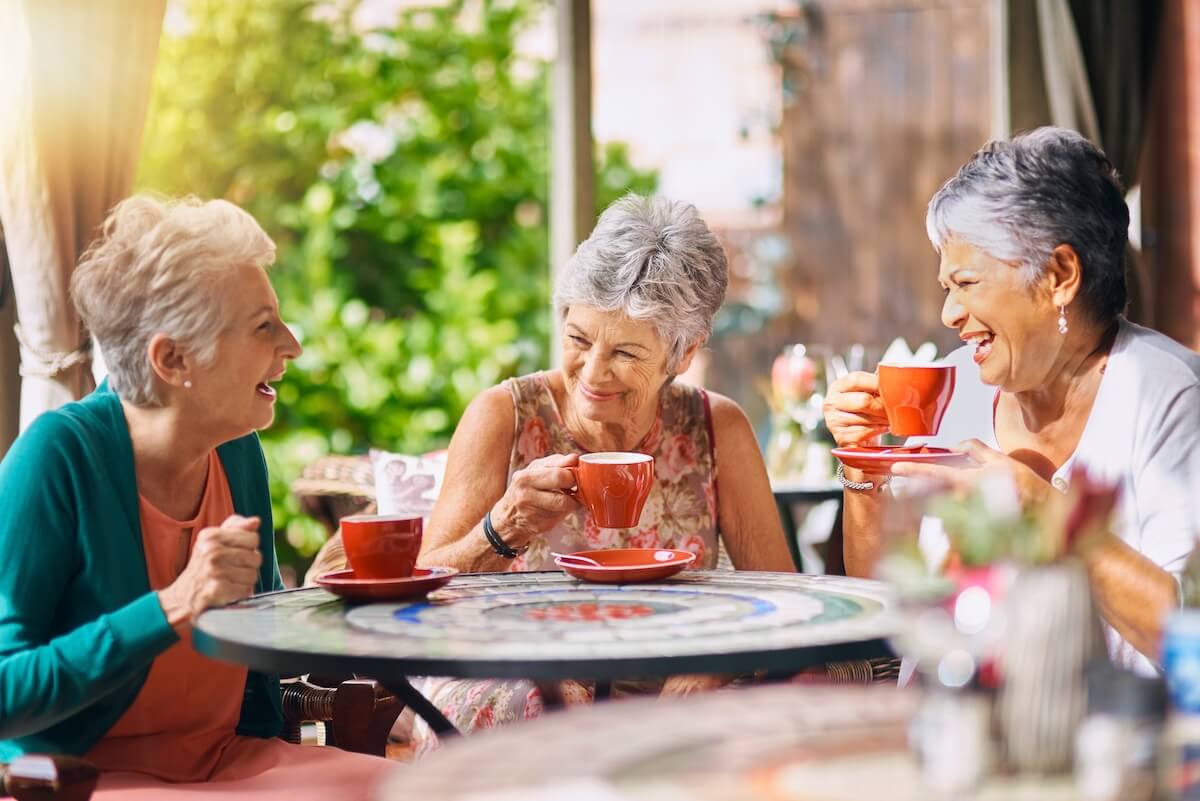 Happy Older Women Socializing and Drinking Coffee