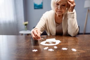 The Truth About What Causes Memory Loss Older woman putting a puzzle together