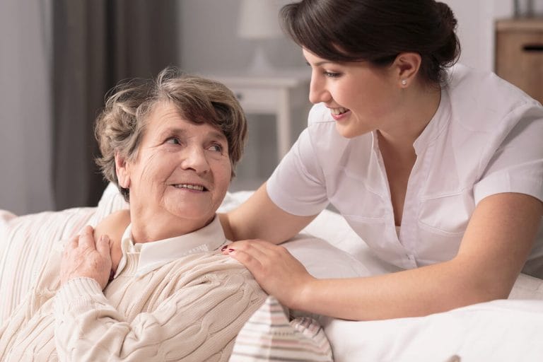 Should You Consider Assisted Living in Boca Raton? Caregiver comforting an older woman.