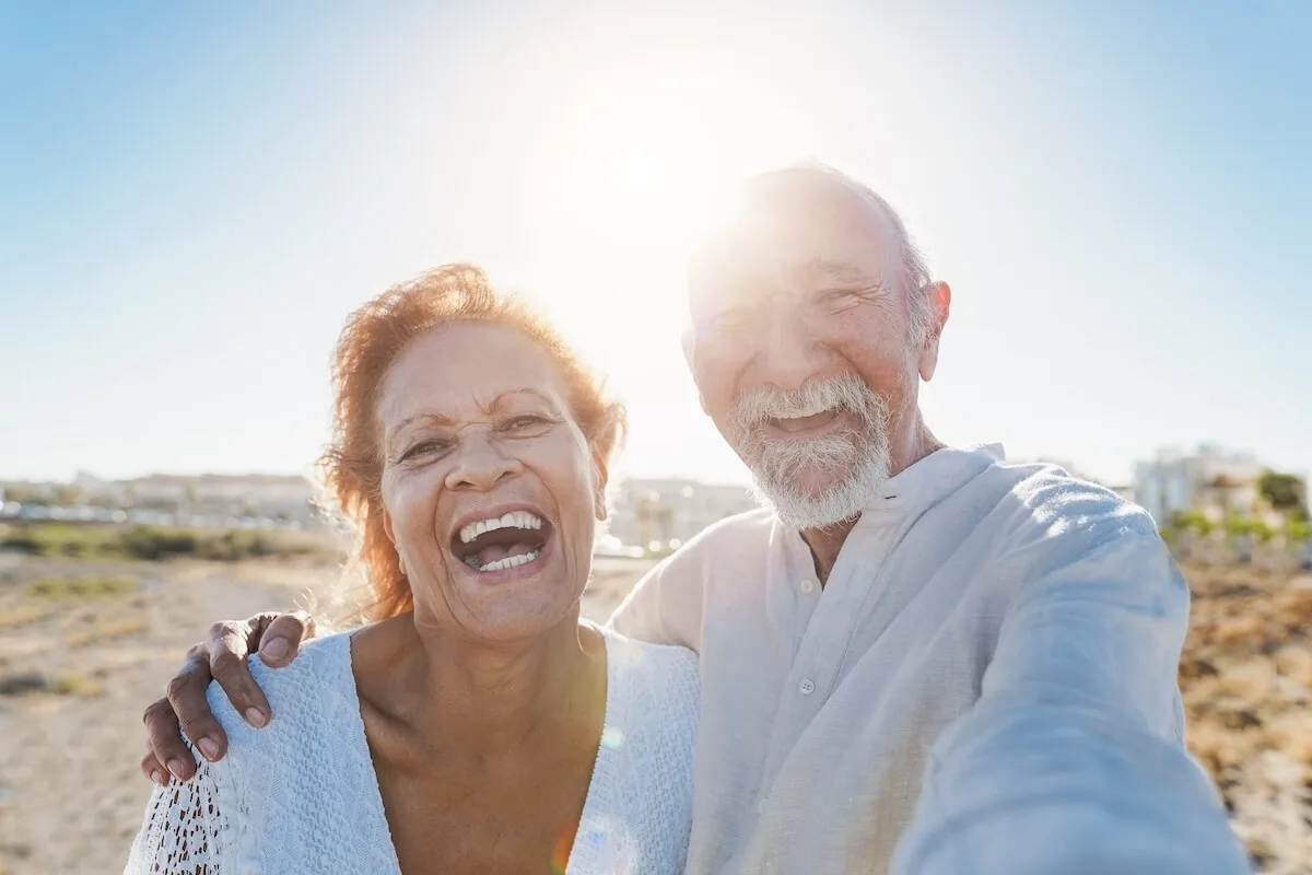Older couple smiling at the beach