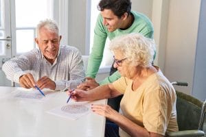 Why Early Dementia Detections Matter Senior couple with son solving maze puzzles as memory training against dementia