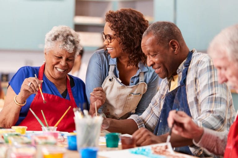 How Art & Creativity Benefit Those Living with Dementia Group of seniors with dementia at an arts and crafts class