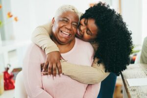 Embrace the Joy of Sharing Your Story: Adult daughter hugging her older mother