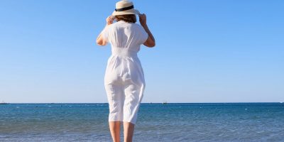 Back View Senior Woman Standing on Beach_Sunscape™ Boca Raton