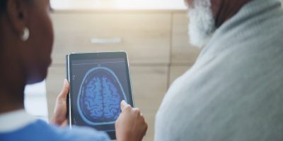 Doctor showing a brain scan to a senior
