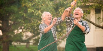 Joyful seniors gardening together