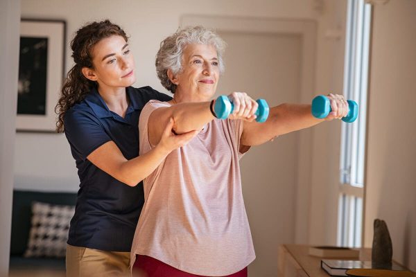 Older woman exercising with dumbbells.