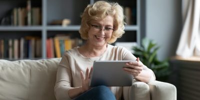 Older woman happily using a tablet