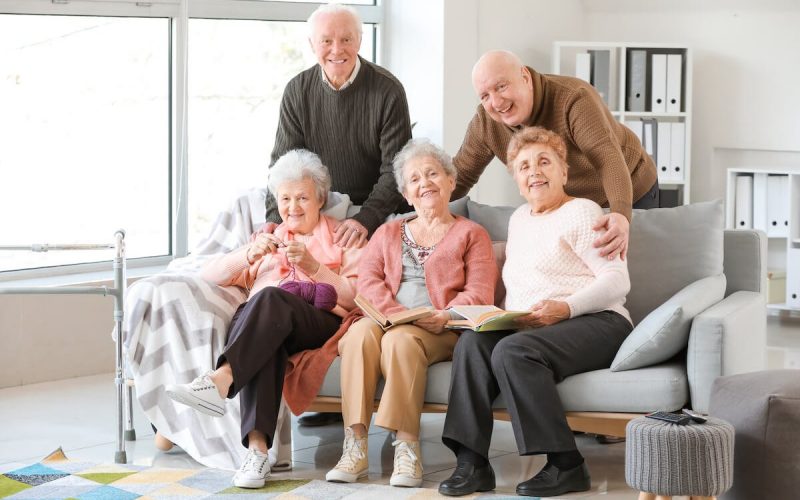 Picture of five seniors at an assisted living community posing together.