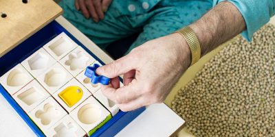 Woman putting puzzle together